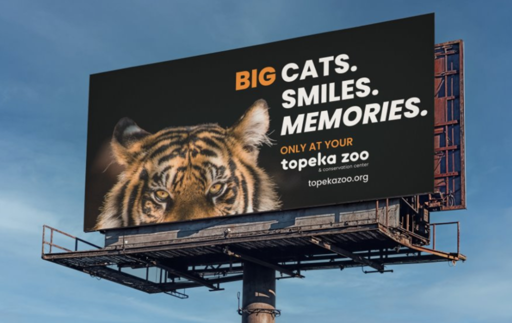 Tiger Trails Topeka Zoo campaign billboard featuring a tiger and messaging promoting conservation and visitor experience.